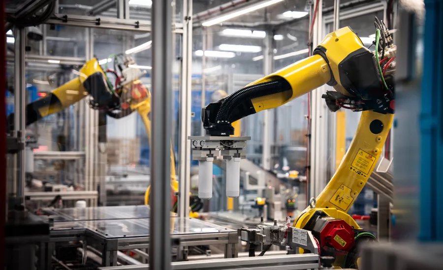 Multiple robotic arms synchronize on the water filter line at Appliance Park in Louisville KY.