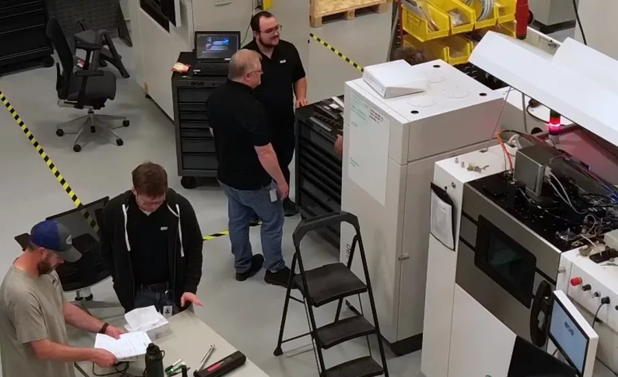 Four people working in the EOS Warehouse