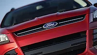 The blue Ford logo appearing on a red vehicle.