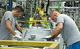 TWO PEOPLE WORK ON WASHING MACHINES AT GE APPLIANCES IN KY