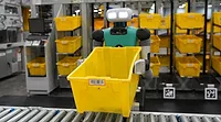 Industrial robots and AI systems operating on a factory floor to improve manufacturing automation and production efficiency Automated manufacturing line with robots and AI technology improving assembly and production operations
