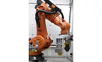 Industrial robot with heavy-duty gripper handling engine components in automated inspection process KUKA industrial robot using end-of-arm tooling to handle heavy engine component in automated manufacturing cell
