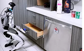 Humanoid Robot Opening Kitchen Drawer With Coca-Cola Products on Counter