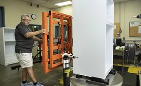 Refrigerator Manufacturing Worker Handling Internal Components Production Line
