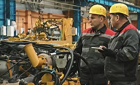 Manufacturing Workers on Production Line Using AI Tools for Troubleshooting and Maintenance