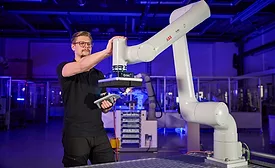 Engineer Operating ABB PoWa Cobot on Assembly Line Collaborative Robot Manufacturing