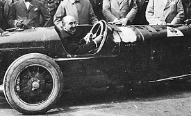 Alfa Romeo founder Nicola Romeo behind the wheel of vintage sports touring vehicle in Italy