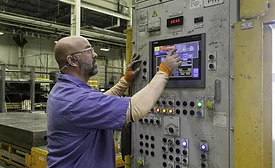 manufacturing employee on an automotive assembly line in a high-volume manufacturing environment