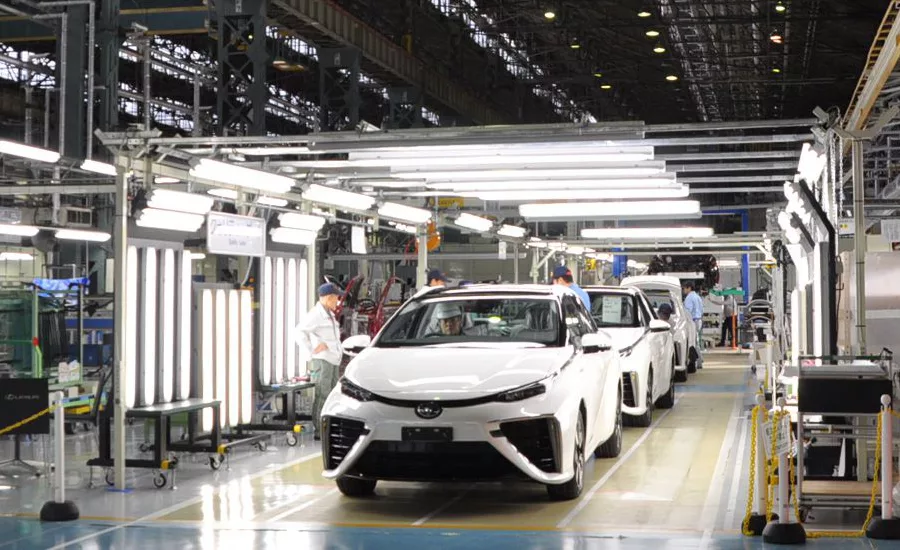 Toyota factory workers assembling vehicles on an automotive production line using advanced manufacturing automation and Factory of the Future technologies in a high-volume assembly plant