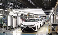 Toyota factory workers assembling vehicles on an automotive production line using advanced manufacturing automation and Factory of the Future technologies in a high-volume assembly plant
