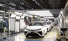 Toyota factory workers assembling vehicles on an automotive production line using advanced manufacturing automation and Factory of the Future technologies in a high-volume assembly plant