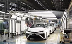 Toyota factory workers assembling vehicles on an automotive production line using advanced manufacturing automation and Factory of the Future technologies in a high-volume assembly plant