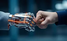 Human worker fist-bumping an AI-powered robot, symbolizing collaboration between human expertise and physical AI in advanced manufacturing and autonomous robotics applications.