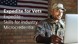 Military veteran participating in advanced manufacturing workforce training program focused on automation, digital engineering and industrial technology careers in a modern factory environment.