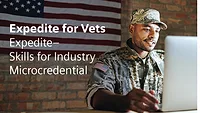 Military veteran participating in advanced manufacturing workforce training program focused on automation, digital engineering and industrial technology careers in a modern factory environment.