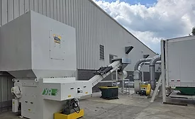 Turnkey system removing wood pallet waste from a production floor for recycling and sustainable secondary use.