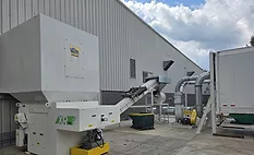 Turnkey system removing wood pallet waste from a production floor for recycling and sustainable secondary use.