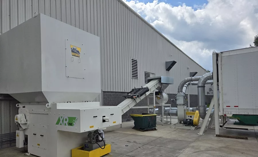Turnkey system removing wood pallet waste from a production floor for recycling and sustainable secondary use.