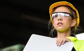 Manufacturing employees operating advanced production equipment in a modern factory as AI infrastructure investment, rising orders and increased output drive U.S. manufacturing growth.