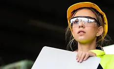 Manufacturing employees operating advanced production equipment in a modern factory as AI infrastructure investment, rising orders and increased output drive U.S. manufacturing growth.