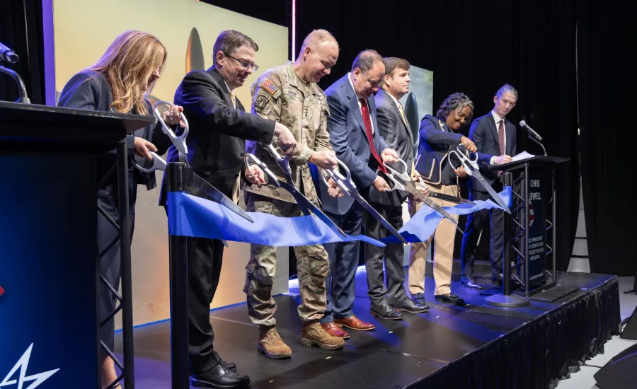 Lockheed Martin executives and officials cut a ribbon at the new missile assembly facility in Courtland, Alabama.