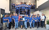 ESCATEC UK team members display the facility’s ISO 13485:2016 certification, which supports certified medical device manufacturing for healthcare OEMs. ESCATEC UK team members hold ISO 13485 certification for medical device manufacturing quality management.