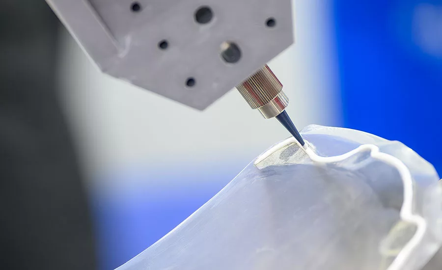 Automated adhesive dispensing on a medical device component.