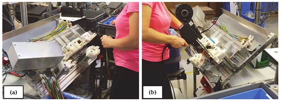 Operator performing wire harness taping at an assembly workstation with cable harnesses, routing fixtures, and a handheld taping tool.
