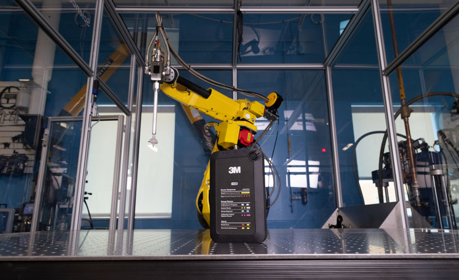Industrial robot and 3M calibration sensor used for automated dispensing process setup, monitoring, and quality control within a robotic manufacturing cell.