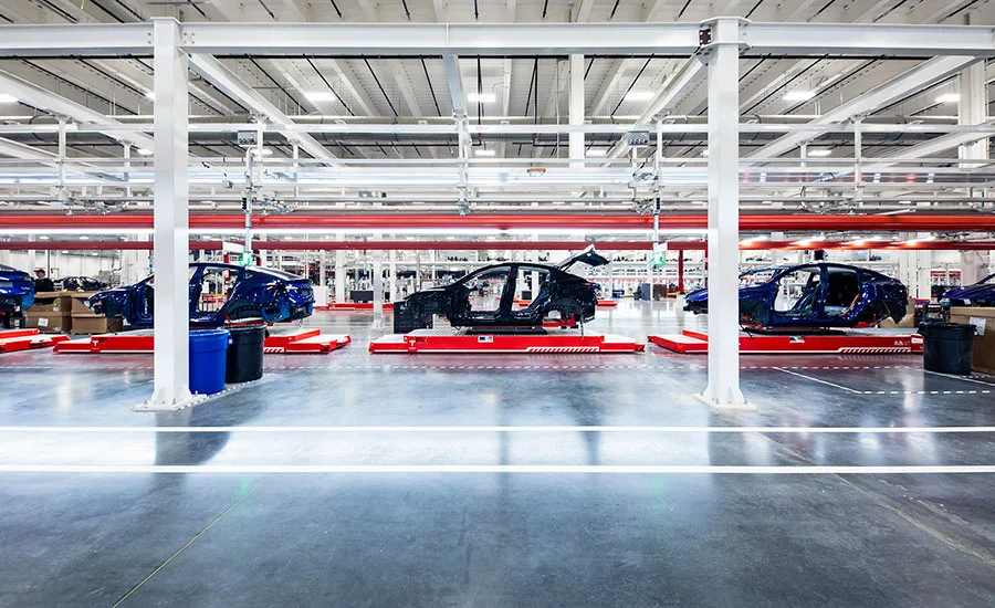 Automotive Assembly Line with Vehicle Body Frames Vehicle body frames moving through an automotive assembly line.