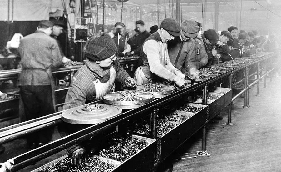 Workers assemble parts on production line