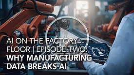 Engineer using a tablet to monitor robotic welding on an automated production line.