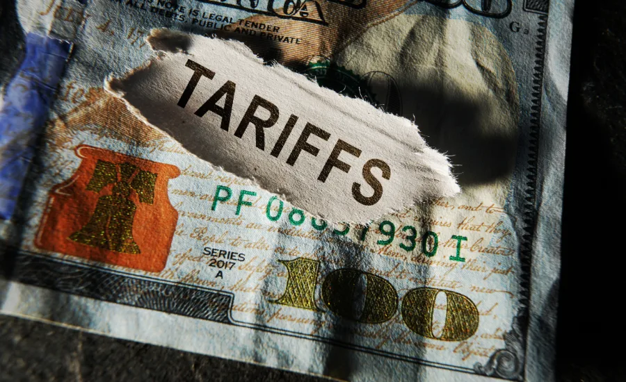 Illustration of U.S. 100 dollar bills representing the financial impact of tariffs on American households.