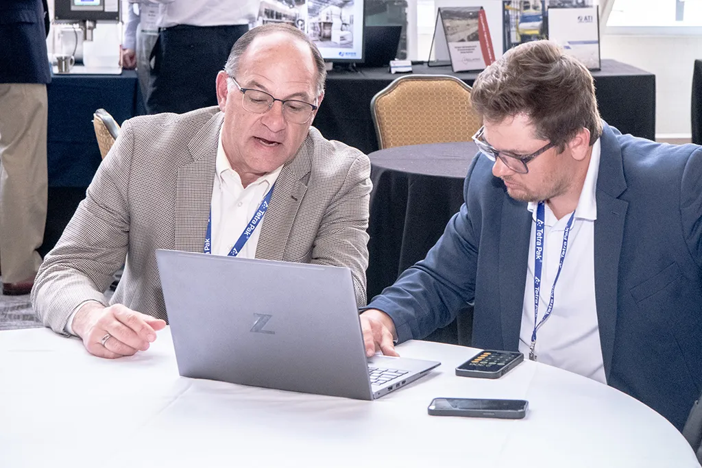 2 men watching a Pre-Event Webinar