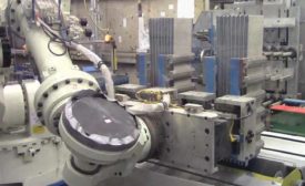 Six-Axis Robot Tends Six-Station Battery Assembly Machine
