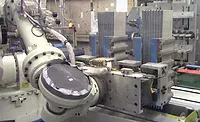 Six-Axis Robot Tends Six-Station Battery Assembly Machine Six-Axis Robot Tends Six-Station Battery Assembly Machine
