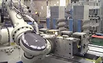 Six-Axis Robot Tends Six-Station Battery Assembly Machine