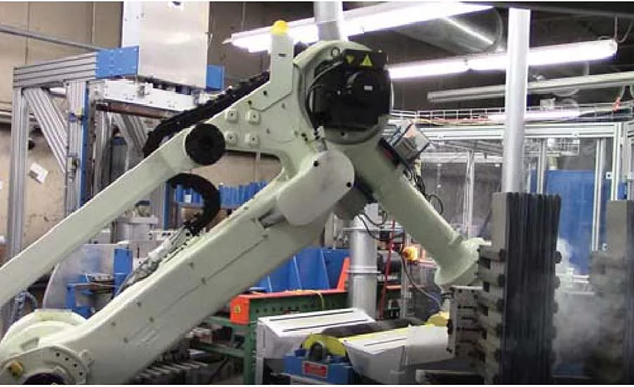 Six-Axis Robot Tends Six-Station Battery Assembly Machine
