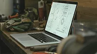 Laptop on the desk with an illustration on the screen.