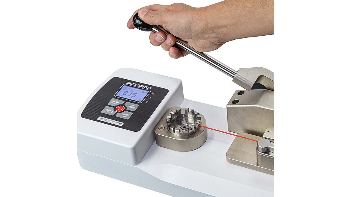 A hand using the Mark-10 handle-pull with a white background.