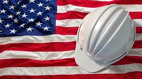 hardhat-on-united-states-of-america-flag-backgroun-2022-12-16-12-14-09-utc.jpg
