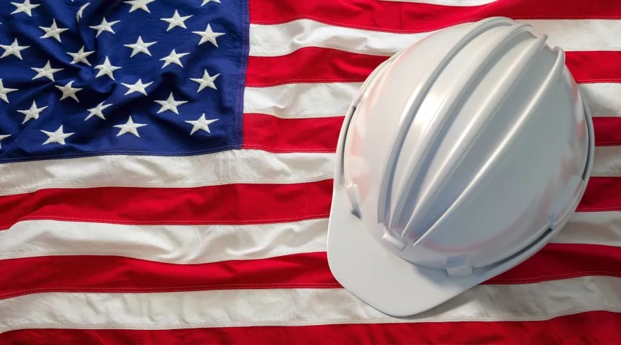 hardhat-on-united-states-of-america-flag-backgroun-2022-12-16-12-14-09-utc.jpg