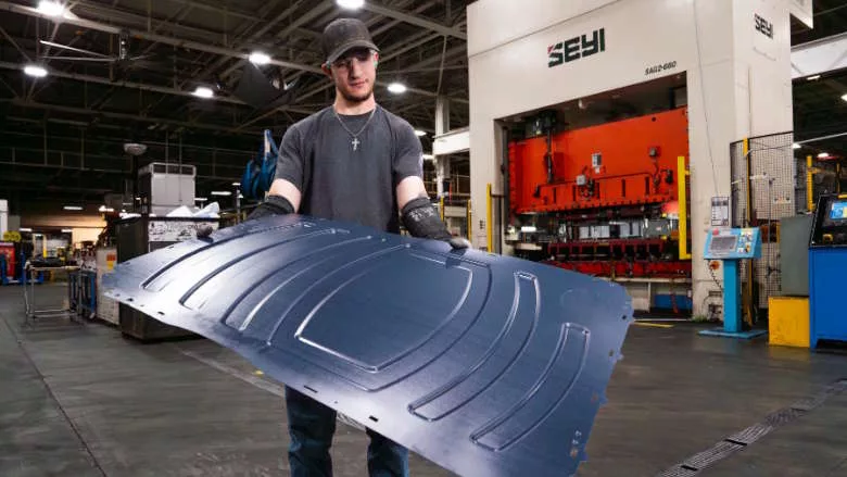 employee handling a part for an appliance