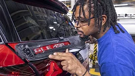 worker assembling a Mercedes-Benz GLE 450 SUV