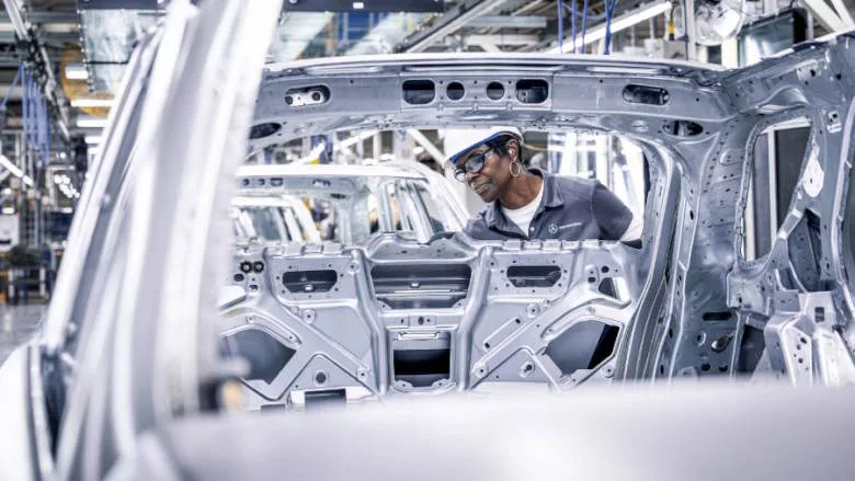 worker on auto assembly line