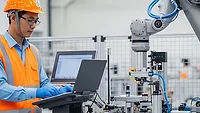 young worker utilizing an industrial robot