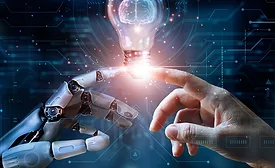 robot hand and human hand touching lightbulb
