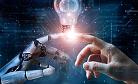 robot hand and human hand touching lightbulb