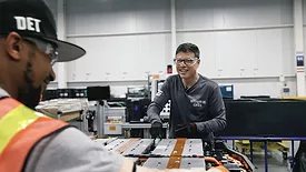 Kurt Kelty, vice president of battery, propulsion and sustainability at General Motors, assembles an EV battery pack.