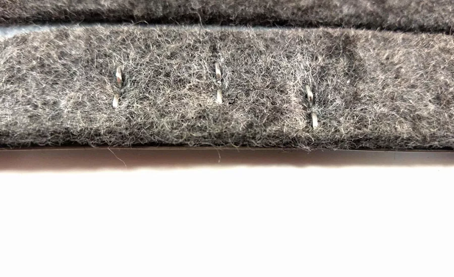 Felt stitched to metal substrate